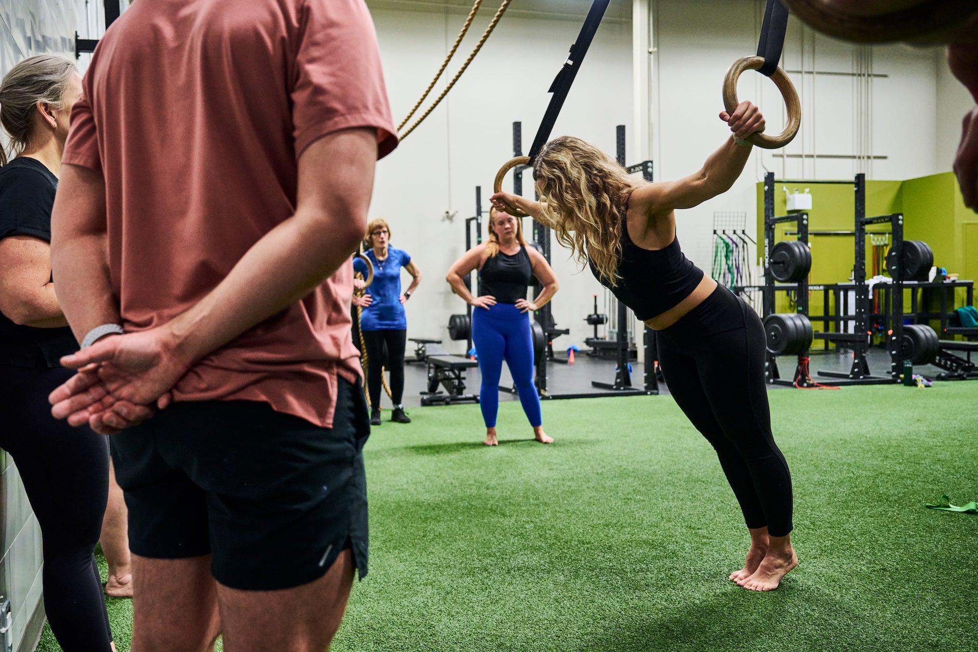 Group fitness members receiving ring instruction at a Group Fitness Class at Human 2.0 Ottawa Physiotherapy, Massage, & Gym South Keys Location