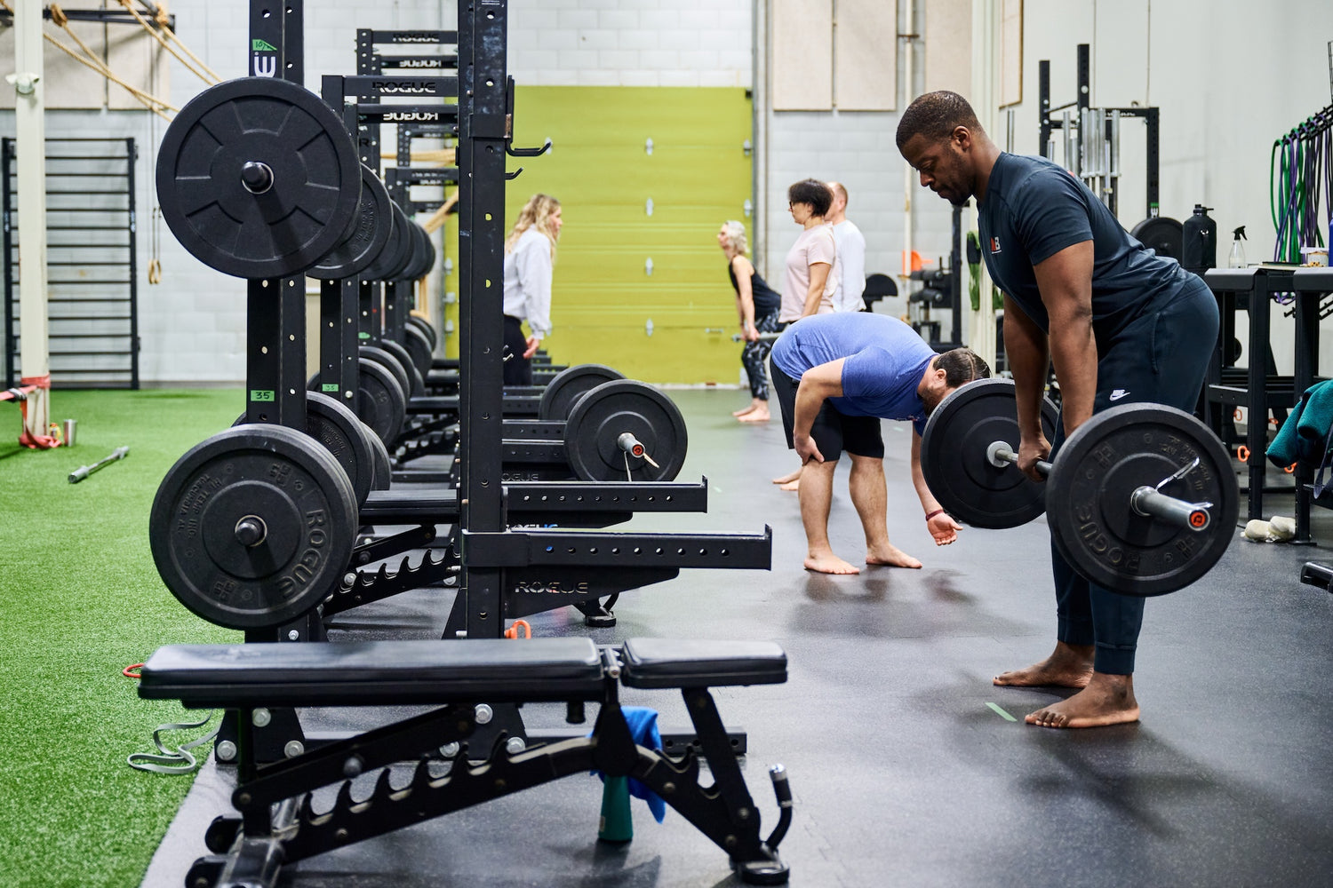Group fitness members perfoming deadlifts at a Group Fitness Class at Human 2.0 Ottawa Physiotherapy, Massage, & Gym South Keys Location