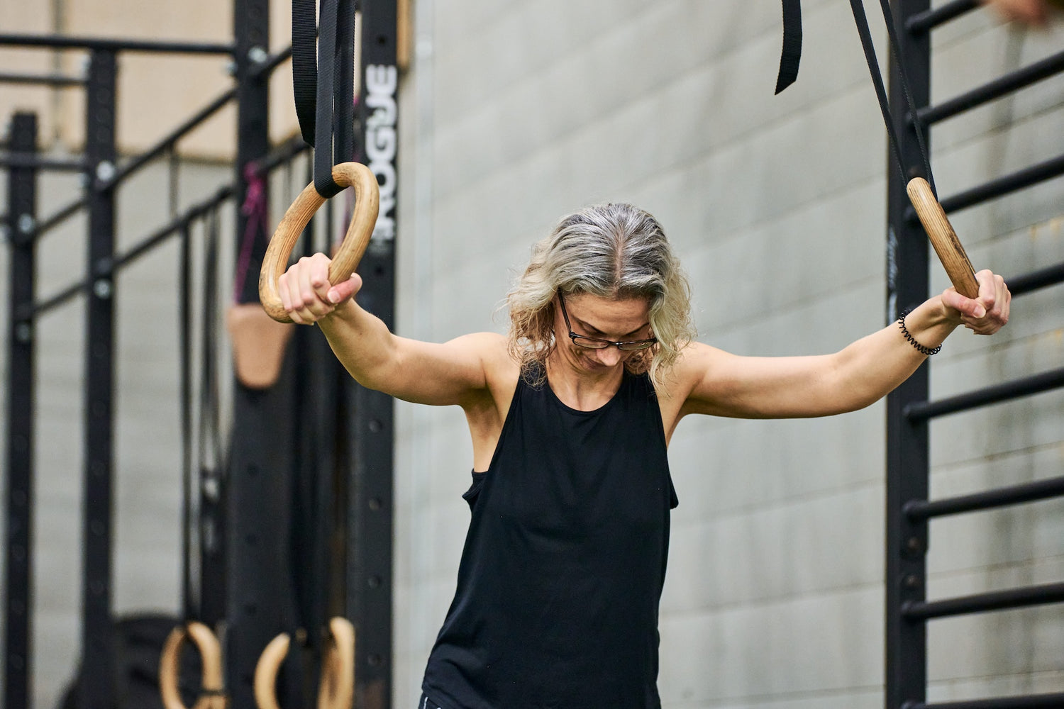Group fitness member performing ring exercise during a group fitness class at Human 2.0 Ottawa Physiotherapy, Massage, & Gym South Keys Location
